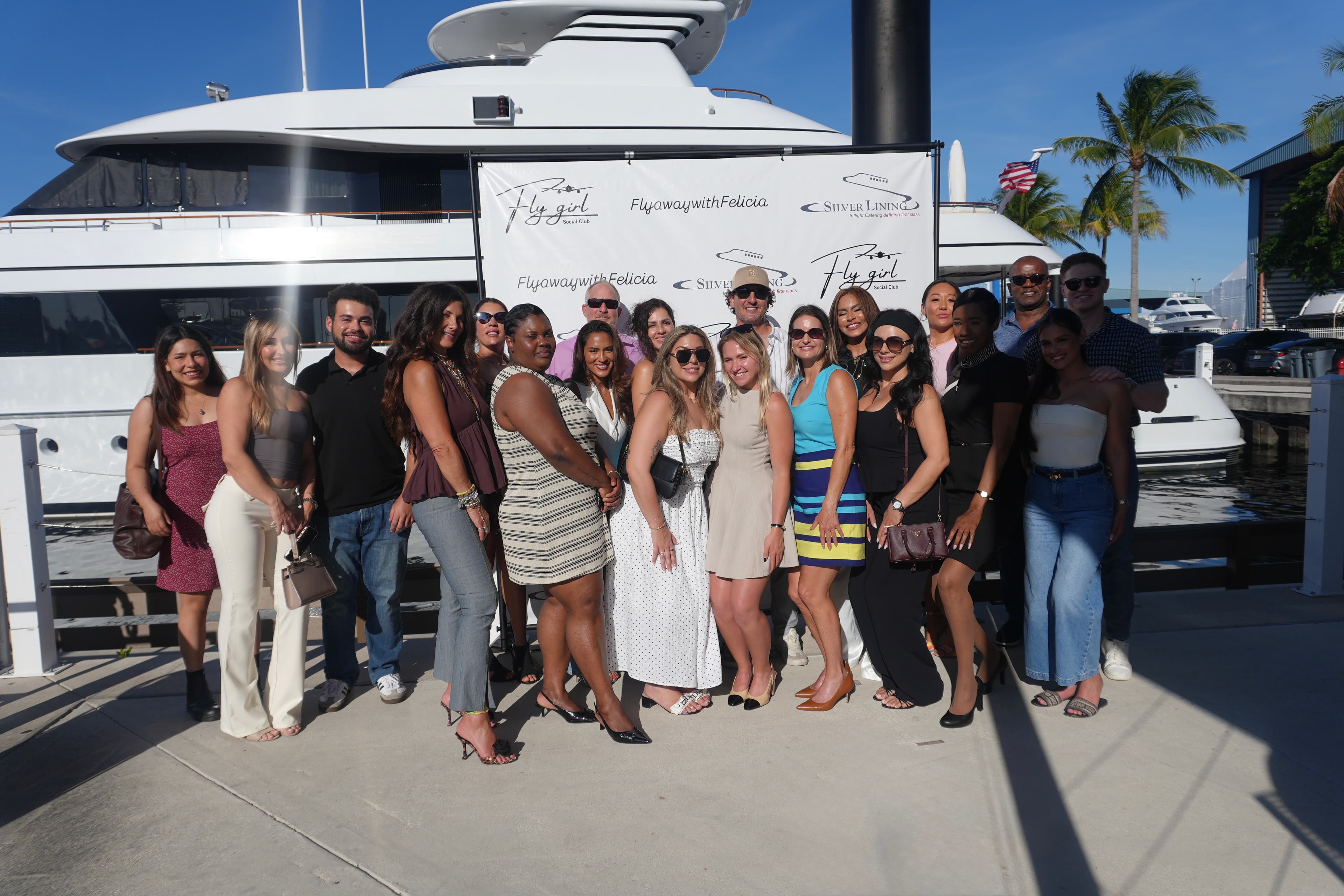 Fly Girl Social Club attendees gathered beside a yacht