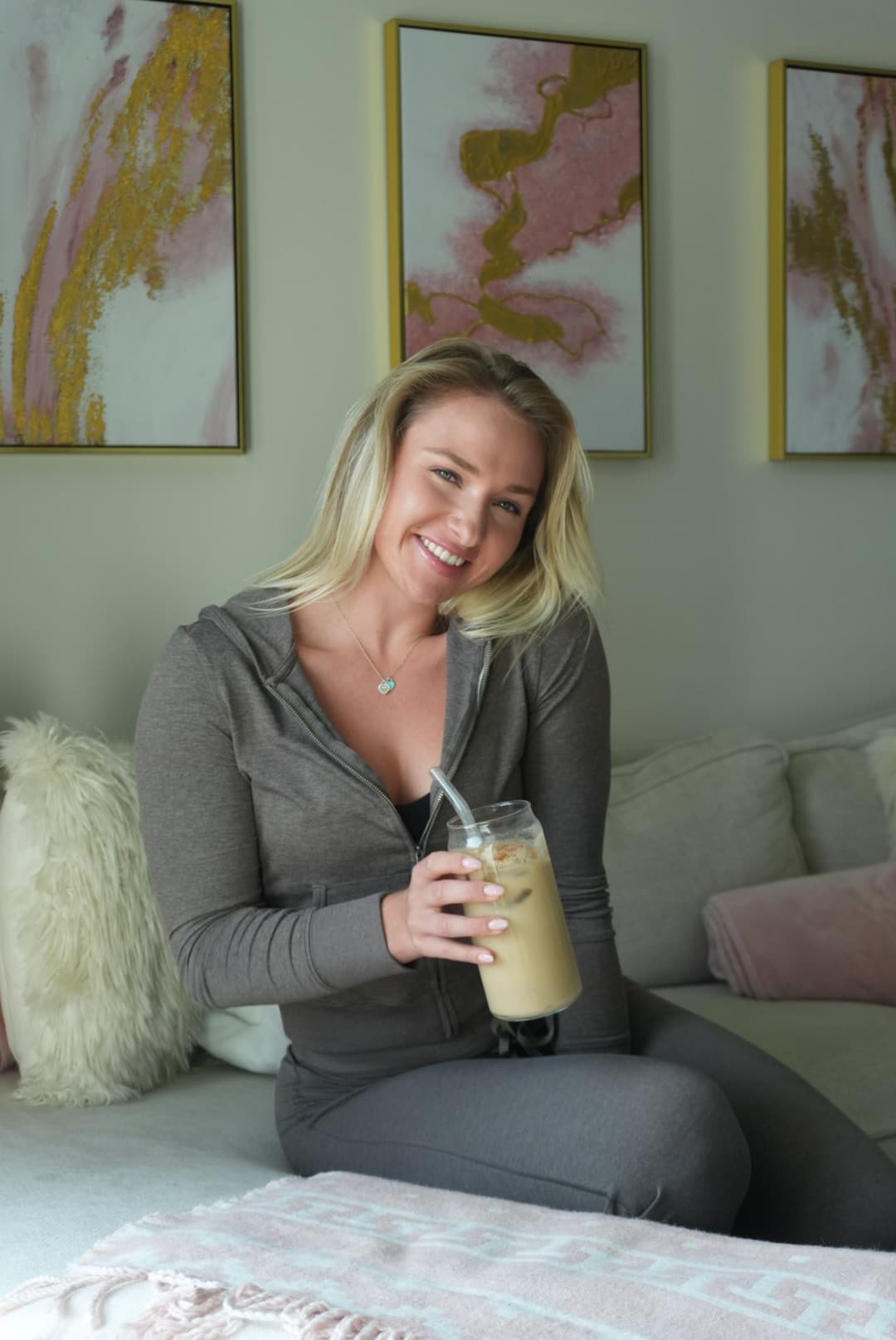 Mercedes smiling in a soft lounge setting for her podcast